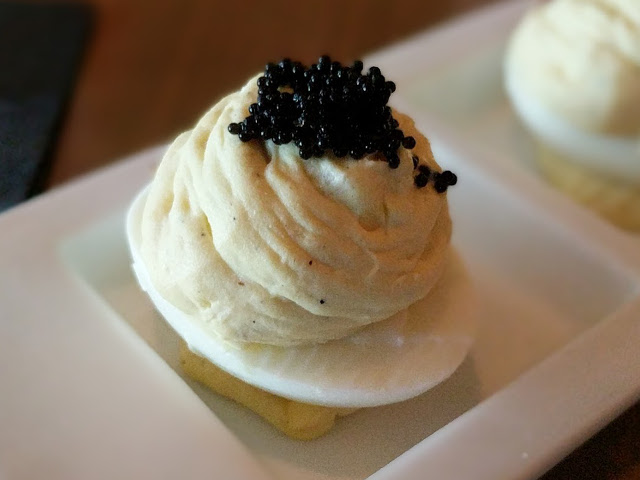 Bacon deviled eggs, topped with caviar.